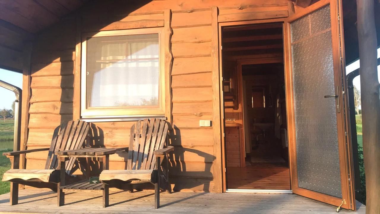 Кемпинги Iecupes wooden cabin with view to river Иецава